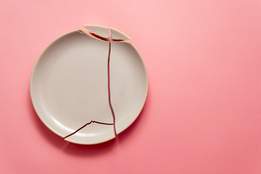 broken plate on pink background